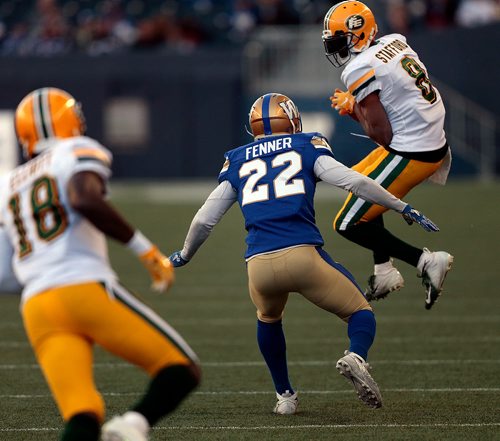 PHIL HOSSACK / WINNIPEG FREE PRESS -Winnipeg Blue Bomber #22 Chandler Fenner closes in as Edmonton Eskimo #8 Kenny Stafford comes down clutching the pass in Pre-Season action at Investor's Group Field Friday.  See story. - May 31, 2019.