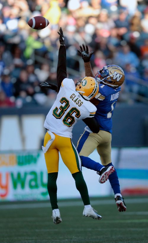 PHIL HOSSACK / WINNIPEG FREE PRESS -Airborne, Winnipeg Blue Bomber receiver #1 Darvin Adams and Edmonton Eskimo #36 Tyquwan battle for the ball in Pre-Season action at Investor's Group Field Friday. #78 Josh Johnson watches the ball. See story.  - May 31, 2019.