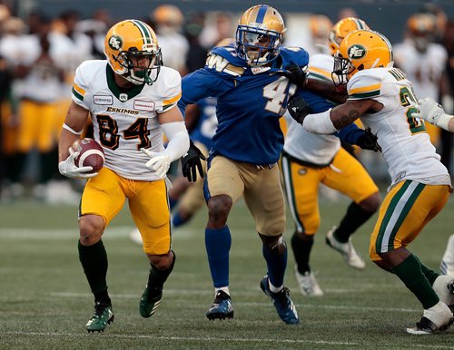 PHIL HOSSACK / WINNIPEG FREE PRESS -Edmonton Eskimo #84 Josh Stangby scampers away from Blue Bomber #41 Abu Conteh in Pre-Season action at Investor's Group Field Friday. See story.  - May 31, 2019.  - May 31, 2019.