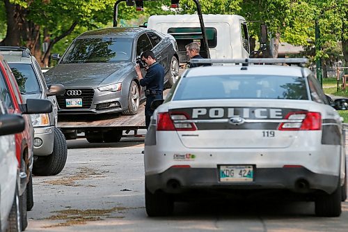 JOHN WOODS / WINNIPEG FREE PRESS
Police forensics takes photos as a car is removed from the 800 block of Winnipeg Ave Sunday, June 2, 2019. Around the corner at Arlington and Notre Dame they were also called to an assault which has now become a homicide.

Reporter: ?