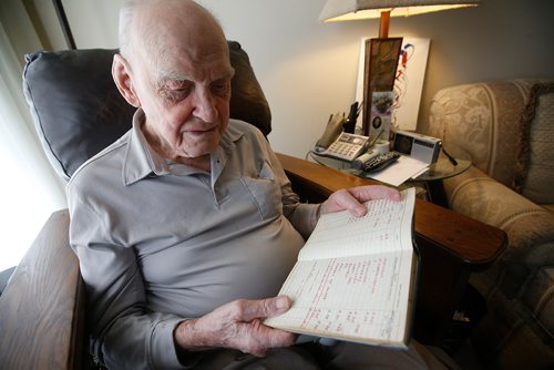 JOHN WOODS / WINNIPEG FREE PRESS
Jim Magill, a Royal Canadian Air Force veteran, is photographed as he looks at his old flight log in his Winnipeg home Wednesday, May 29, 2019. He was in the air during D-Day.

Reporter: Kevin Rollason