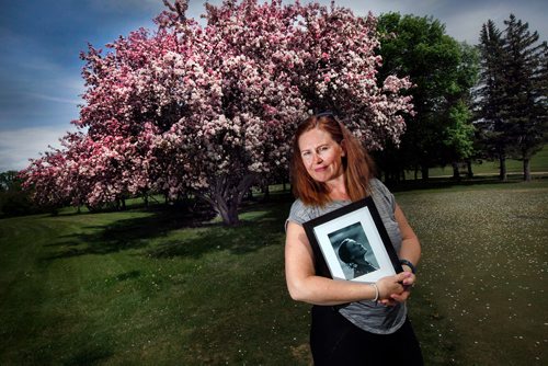 PHIL HOSSACK / WINNIPEG FREE PRESS - Melissa Winter created and runs an annual event called "Flowers in Her Hair" to support the Mood Disorders Association of Manitoba after her daughter died of suicide four years ago. She's posing with a photo of her daughter at the venue for the annual event. See story. - June 5, 2019.