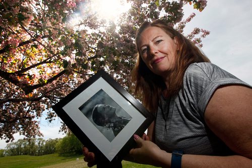 PHIL HOSSACK / WINNIPEG FREE PRESS - Melissa Winter created and runs an annual event called "Flowers in Her Hair" to support the Mood Disorders Association of Manitoba after her daughter died of suicide four years ago. She's posing with a photo of her daughter at the venue for the annual event. See story.  - June 5, 2019.