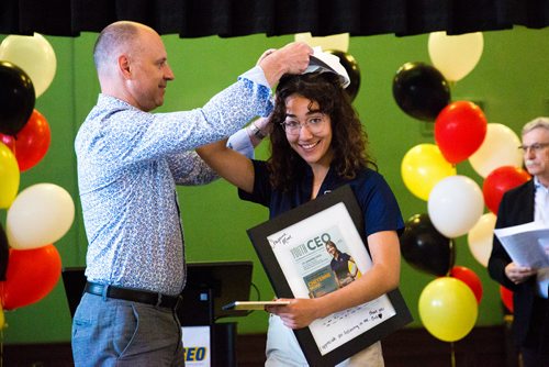 MIKAELA MACKENZIE / WINNIPEG FREE PRESS
Winnipeg Free Press editor Paul Samyn puts a ball cap on Youth CEO Cheyenne Moar at the Youth CEO program kickoff at the Neeginan Centre in Winnipeg on Thursday, June 6, 2019. For Alex Paul story.  
Winnipeg Free Press 2019.