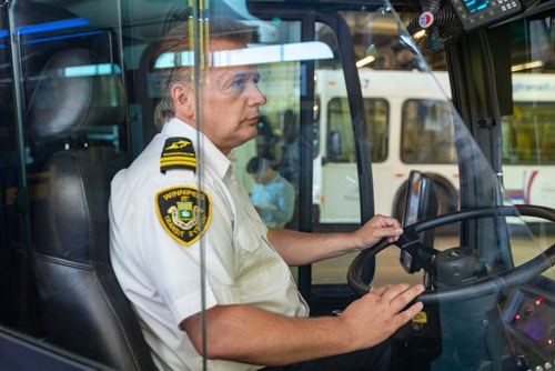 SASHA SEFTER / WINNIPEG FREE PRESS
Chief Timekeeper for Winnipeg Transit Blaine Early sits in a bus with a safety shield during a press conference to showcase newly-installed bus operator safety shields at the Winnipeg Transit Brandon Garage.
190606 - Thursday, June 06, 2019.