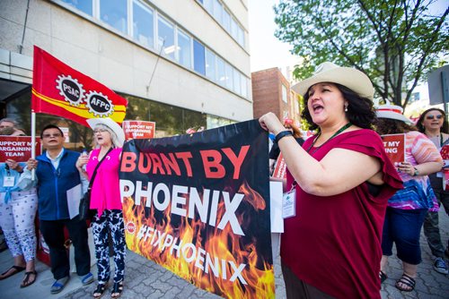 MIKAELA MACKENZIE / WINNIPEG FREE PRESS
Union activist Lisa Robillard (right) holds a banner at a rally against "unacceptable" Pheonix pay system compensation in Winnipeg on Thursday, June 6, 2019. For Nadya Pankiw story.  
Winnipeg Free Press 2019.