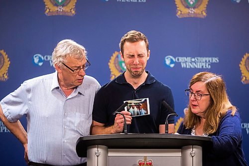 MIKAELA MACKENZIE / WINNIPEG FREE PRESS
Michael Silicz, brother of the victim, reads a statement with parents Walter (left) and Nicole Silicz at a media briefing about the homicide of Justin Silicz at the police headquarters in Winnipeg on Friday, June 7, 2019. For Katie May story.  
Winnipeg Free Press 2019.