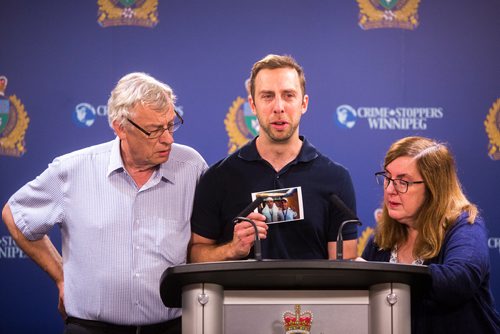 MIKAELA MACKENZIE / WINNIPEG FREE PRESS
Michael Silicz, brother of the victim, reads a statement with parents Walter (left) and Nicole Silicz at a media briefing about the homicide of Justin Silicz at the police headquarters in Winnipeg on Friday, June 7, 2019. For Katie May story.  
Winnipeg Free Press 2019.