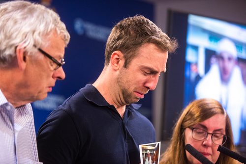 MIKAELA MACKENZIE / WINNIPEG FREE PRESS
Michael Silicz, brother of the victim, reads a statement with parents Walter (left) and Nicole Silicz at a media briefing about the homicide of Justin Silicz at the police headquarters in Winnipeg on Friday, June 7, 2019. For Katie May story.  
Winnipeg Free Press 2019.