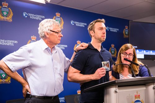 MIKAELA MACKENZIE / WINNIPEG FREE PRESS
Michael Silicz, brother of the victim, reads a statement with parents Walter (left) and Nicole Silicz at a media briefing about the homicide of Justin Silicz at the police headquarters in Winnipeg on Friday, June 7, 2019. For Katie May story.  
Winnipeg Free Press 2019.