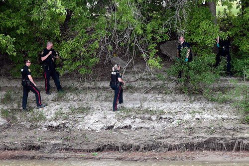 PHIL HOSSACK / WINNIPEG FREE PRESS - Police investigate a crime scene along the west bank of the Red River near the Forks Historic Site Friday afternoon. See Rollison's story. - June 7, 2019.