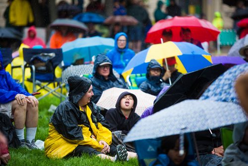 MIKAELA MACKENZIE / WINNIPEG FREE PRESS
Chad Honke, ten, catches raindrops on his tongue during a downpour at the Rise Up 100: Songs for the Next Century Concert at Old Market Square in Winnipeg on Saturday, June 8, 2019. For Nadya story.  
Winnipeg Free Press 2019.