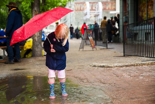 MIKAELA MACKENZIE / WINNIPEG FREE PRESS
Rhiannon Mann, six, splashes in a puddle at the Rise Up 100: Songs for the Next Century Concert at Old Market Square in Winnipeg on Saturday, June 8, 2019. For Nadya story.  
Winnipeg Free Press 2019.