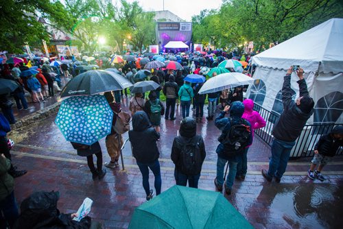 MIKAELA MACKENZIE / WINNIPEG FREE PRESS
Bruce Cockburn plays before a sea of umbrellas at the Rise Up 100: Songs for the Next Century Concert at Old Market Square in Winnipeg on Saturday, June 8, 2019. For Nadya story.  
Winnipeg Free Press 2019.