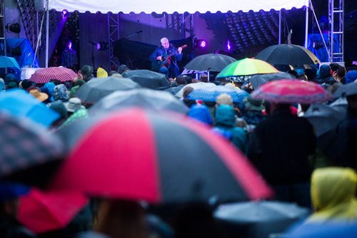 MIKAELA MACKENZIE / WINNIPEG FREE PRESS
Bruce Cockburn plays before a sea of umbrellas at the Rise Up 100: Songs for the Next Century Concert at Old Market Square in Winnipeg on Saturday, June 8, 2019. For Nadya story.  
Winnipeg Free Press 2019.