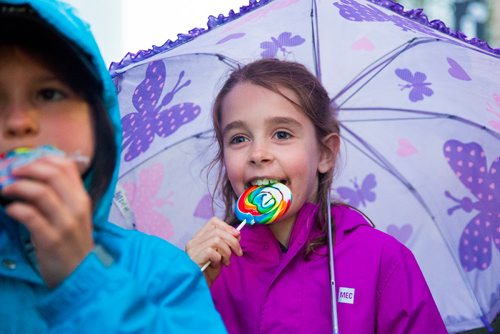 MIKAELA MACKENZIE / WINNIPEG FREE PRESS
Charlotte Hill, nine (right) and Natalie Phibbs, eight, eat lollipops (a candy that existed during the time of the strike) at the Rise Up 100: Songs for the Next Century Concert at Old Market Square in Winnipeg on Saturday, June 8, 2019. For Nadya story.  
Winnipeg Free Press 2019.