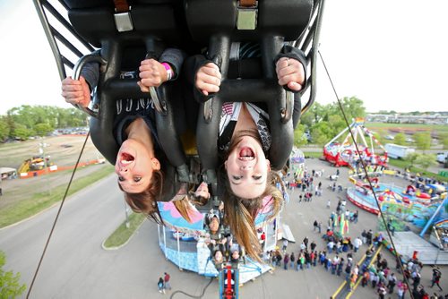 Brandon Sun 05062009 (L-R) Ashley Dreher and Danielle Lenton scream as they go upside down while riding the Fireball on the Midway at the 2009 Manitoba Summer Fair in Brandon on Friday evening. (Tim Smith/Brandon Sun)