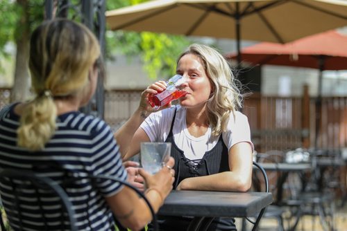 SASHA SEFTER / WINNIPEG FREE PRESS
Courtney Riel enjoys a drink with a friend on the patio of Stellas in the Centre Culturel Franco-Manitobain in Saint Boniface.
190607 - Friday, June 07, 2019.