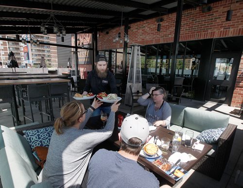 PHIL HOSSACK / WINNIPEG FREE PRESS - Waiter Patrick Hart serves up lunch at Fionns Patio at Grant Park.  See Jill's story. - June 10, 2019.