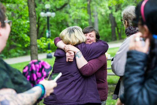 MIKAELA MACKENZIE / WINNIPEG FREE PRESS
Nicole Last, City of Winnipeg gardener who lost her brother to addiction hugs friend Marcheta Tanner before planting a new memorial garden for loved ones lost to addictions and overdose on Waterfront Drive in Winnipeg on Tuesday, June 11, 2019. For Caitlyn Gowriluk story.  
Winnipeg Free Press 2019.