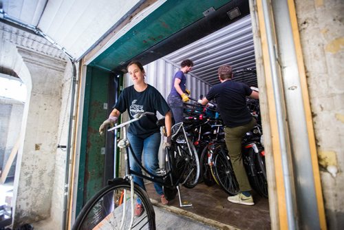 MIKAELA MACKENZIE / WINNIPEG FREE PRESS
Leigh Anne Parry (left), Anders Swanson, and Ian Frank, co-founders of the Plain Bicycle Project, unload old Dutch bikes in a shipping container in Winnipeg on Tuesday, June 11, 2019. For Alex Paul story.  
Winnipeg Free Press 2019.