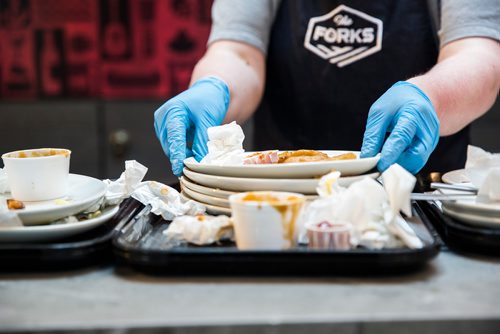 MIKAELA MACKENZIE / WINNIPEG FREE PRESS
Heather Baril, cleaning staff, sorts and scrapes plates at The Forks in Winnipeg on Tuesday, June 11, 2019. The Forks recently replaced dishware with 100% reusable and compostable products in its path towards a zero-waste goal. For Tessa Vanderhart story.  
Winnipeg Free Press 2019.