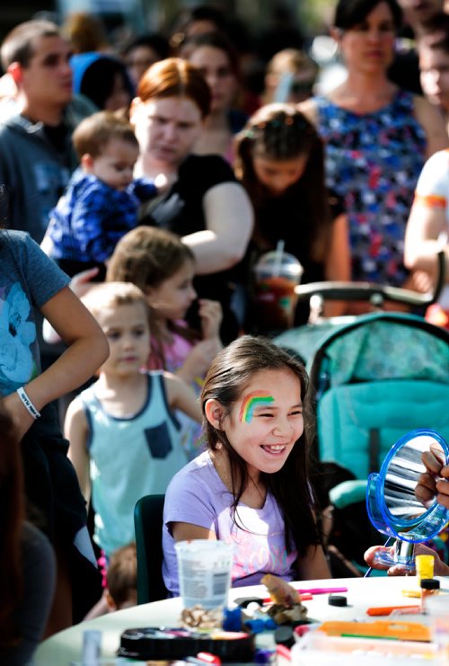PHIL HOSSACK / WINNIPEG FREE PRESS - * yr old Josie Okema beams as she looks at the reflection of a rainbow painted on her face at an inner city block party along Aberdeen between Powers and Salter. See release.  - June 12, 2019. PHIL HOSSACK / WINNIPEG FREE PRESS -  - June 12, 2019.