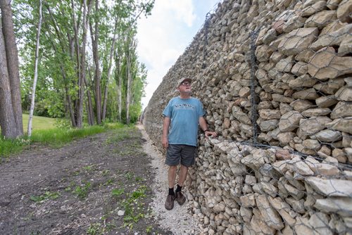 SASHA SEFTER / WINNIPEG FREE PRESS
Perry Kowal's house borders onto a new retaining wall which developers have installed in order to massively expand a trailer park. Kowal stands 5'8'' and believes the retaining Wass is at least 10 feet high.
190613 - Thursday, June 13, 2019.