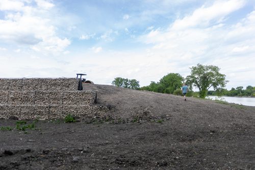 SASHA SEFTER / WINNIPEG FREE PRESS
Perry Kowal walks up a dirt hill to get a better look at a new retaining wall next to his house which developers have installed in order to massively expand a trailer park. 
190613 - Thursday, June 13, 2019.
