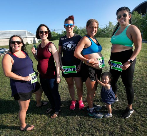 PHIL HOSSACK / WINNIPEG FREE PRESS - Left to right pregnant marathoners; Ashly Reyes, Maddie Fontaine, Breanne Peters, Reesa Simmonds (and her 16 mo old daughter Jordan) and Marie Lospe pose with their numbers for Sunday's Marathon. The five expectant mothers are running a relay race. See story. - June 14 2019.
