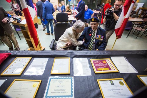 MIKAELA MACKENZIE / WINNIPEG FREE PRESS
Former corporal Ian Wilson and his wife Betty Wilson look at a display of photos before Ian receives the Legion of Honour at Deer Lodge Centre in Winnipeg on Saturday, June 15, 2019. For Caitlin Gowriluk story.
Winnipeg Free Press 2019.