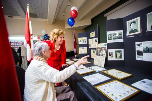 MIKAELA MACKENZIE / WINNIPEG FREE PRESS
Betty Wilson (Ian's wife) and Radcliffe Rochon (Ian's granddaughter) look at a display of pictures before former corporal Ian Wilson receives the Legion of Honour at Deer Lodge Centre in Winnipeg on Saturday, June 15, 2019. For Caitlin Gowriluk story.
Winnipeg Free Press 2019.