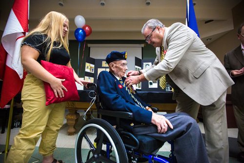 MIKAELA MACKENZIE / WINNIPEG FREE PRESS
Former corporal Ian Wilson receives the Legion of Honour from honourary French consulate Bruno Burnichon as great-granddaughter Kylee Rochon (left) watches at Deer Lodge Centre in Winnipeg on Saturday, June 15, 2019. For Caitlin Gowriluk story.
Winnipeg Free Press 2019.