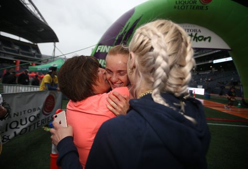 TREVOR HAGAN / WINNIPEG FREE PRESS
Selene Sharpe, winner of the womens full Manitoba Marathon, middle, embraced by her mom, Patti, and sister, Hailey, both of whom also ran, Sunday, June 16, 2019.