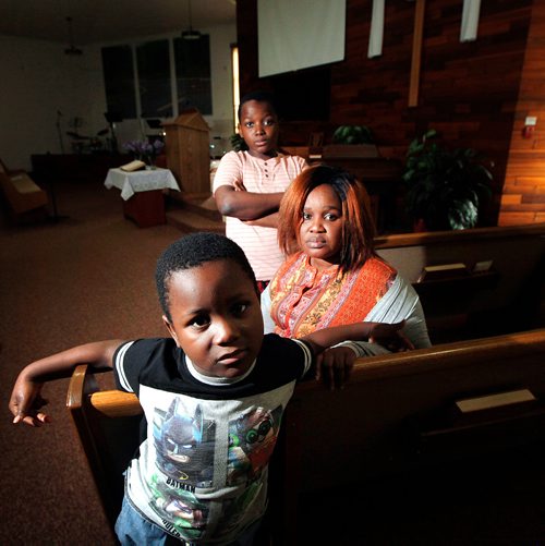 PHIL HOSSACK / WINNIPEG FREE PRESS - Fatmata Kargbo with her sons Thaduba (12yrs) top, and Mathebeh (6yrs) bottom in the Sanctuary of Chrestview Fellowship Church Monday. See Brenda Suderman's story.  - June 17, 2019.