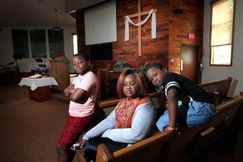 PHIL HOSSACK / WINNIPEG FREE PRESS - Fatmata Kargbo with her sons Thaduba (12yrs) left, and Mathebeh (6yrs) right in the Sanctuary of Chrestview Fellowship Church Monday. See Brenda Suderman's story.  - June 17, 2019.