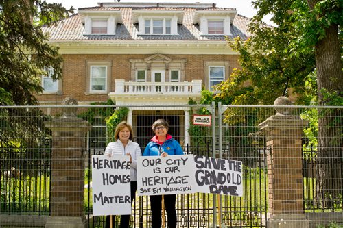 Canstar Community News June 11, 2019 - Mary Hall and Christine Skene demonstrate outside of 514 Wellington Crescent in Crescentwood. The stately mansion, over a century old, was threatened with demolition on June 6. The building was saved when the City of Winnipeg director of planning, property, and development nominated Crescentwood as a hertiage conservation district, setting a potential two year process in motion. (DANIELLE DA SILVA/SOUWESTER/CANSTAR)