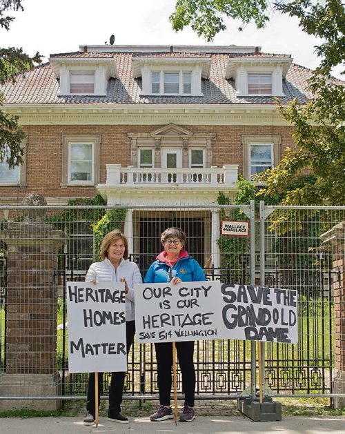 Canstar Community News June 11, 2019 - Mary Hall and Christine Skene demonstrate outside of 514 Wellington Crescent in Crescentwood. The stately mansion, over a century old, was threatened with demolition on June 6. The building was saved when the City of Winnipeg director of planning, property, and development nominated Crescentwood as a hertiage conservation district, setting a potential two year process in motion. (DANIELLE DA SILVA/SOUWESTER/CANSTAR)