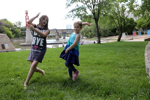 RUTH BONNEVILLE /  WINNIPEG FREE PRESS 

Standup photo 

Sonia Ozsuath (10yrs) from Budapest Hungary who is with her parents visiting family in Winnipeg, dances with her little cousin, Anna Fischer, from Winnipeg (5yrs), on the grass at the Forks Tuesday.

Standup photo 

June 18th, 2019
