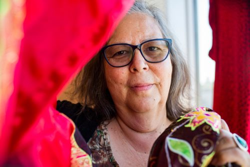 MIKAELA MACKENZIE / WINNIPEG FREE PRESS
Darlene Douglas, New Directions director of culture, education and training, with two of the 350 red dresses that theyre hanging Thursday in every window of their building at 717 Portage in Winnipeg on Wednesday, June 19, 2019. For Carol Sanders story.
Winnipeg Free Press 2019.