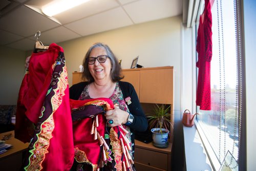 MIKAELA MACKENZIE / WINNIPEG FREE PRESS
Darlene Douglas, New Directions director of culture, education and training, with two of the 350 red dresses that theyre hanging Thursday in every window of their building at 717 Portage in Winnipeg on Wednesday, June 19, 2019. For Carol Sanders story.
Winnipeg Free Press 2019.