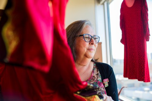 MIKAELA MACKENZIE / WINNIPEG FREE PRESS
Darlene Douglas, New Directions director of culture, education and training, with two of the 350 red dresses that theyre hanging Thursday in every window of their building at 717 Portage in Winnipeg on Wednesday, June 19, 2019. For Carol Sanders story.
Winnipeg Free Press 2019.