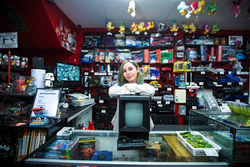 MIKAELA MACKENZIE / WINNIPEG FREE PRESS
Cobra Collectibles manager Kailyn Gregorash poses for a photo with a Vectrex in front of vintage video game consoles in the store in Winnipeg on Thursday, June 20, 2019. For Declan story.
Winnipeg Free Press 2019.