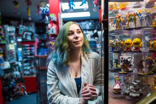 MIKAELA MACKENZIE / WINNIPEG FREE PRESS
Cobra Collectibles manager Kailyn Gregorash poses for a photo among vintage video game paraphernalia in the store in Winnipeg on Thursday, June 20, 2019. For Declan story.
Winnipeg Free Press 2019.