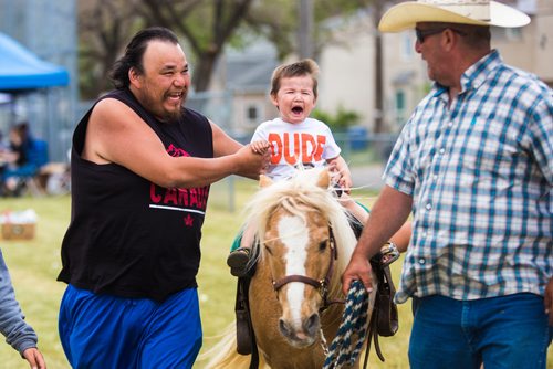 MIKAELA MACKENZIE / WINNIPEG FREE PRESS
Jace Keeper, two, decides that he doesn't like the pony ride as his uncle, Rocky Hudson, holds him up and Barry Sanderson leads the pony at Aboriginal Day festivities at the Freighthouse Community Centre in Winnipeg on Friday, June 21, 2019. 
Winnipeg Free Press 2019.