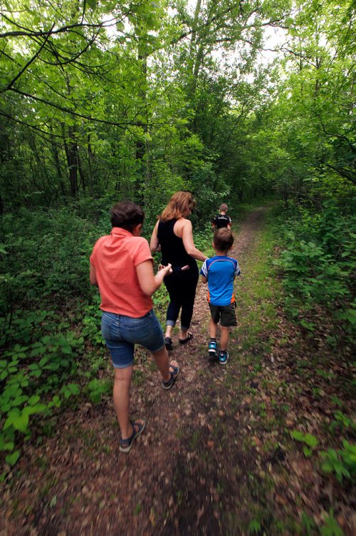 PHIL HOSSACK / WINNIPEG FREE PRESS -  Lorna Kroeker and her kids Brynn (13) left, Rylan (7) and Grayson (10) leading the way head into the network of trails around St Vital Park to leave painted rocks for visitors to find.  See Dave Sanderson story? - June 18, 2019.