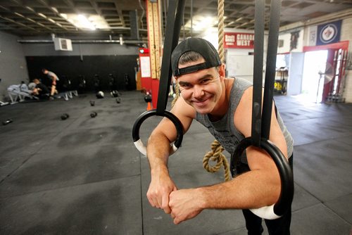 PHIL HOSSACK / WINNIPEG FREE PRESS - Ryan Stewart grins at the camera at his Berry ave Crossfit 204 gym.. See Sabrina Carnevale story.  - July 3, 2019.