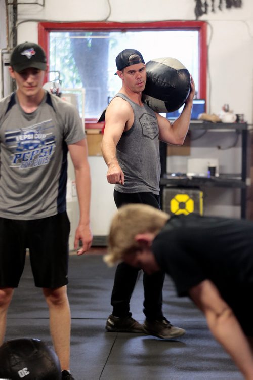 PHIL HOSSACK / WINNIPEG FREE PRESS - Ryan Stewart oversees Cole Younger (grey shirt) and Easton Lewicki (black shirt) at the Cross Fit 204 Gym Wednesday evening. The 15 yr old teenagers are part of a summer fitness program. See Sabrina Carnevale story.  - July 3, 2019.