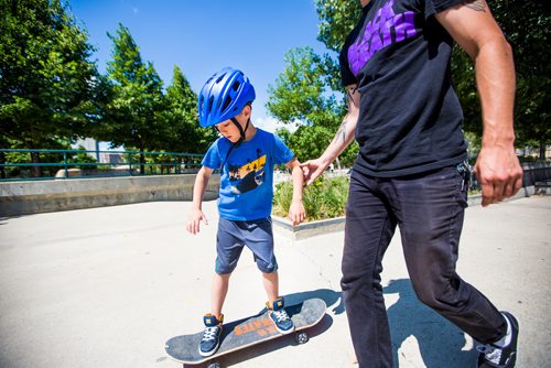 MIKAELA MACKENZIE / WINNIPEG FREE PRESS
Oliver Mason, six, learns to skateboard with instructor Craig Henry at the free skateboarding lessons for beginners, put on by the Winnipeg Skateboarding Outreach Organization and Sk8 Skates, at the Forks skate park in Winnipeg on Wednesday, July 10, 2019. Standup.
Winnipeg Free Press 2019.