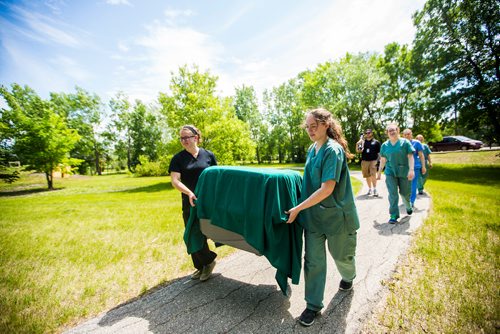 MIKAELA MACKENZIE / WINNIPEG FREE PRESS
Caitlyn Kuprowski (left) and Tanisha Kroeker, Wildlife Haven Rehabilitation Centre animal care staff, carry a juvenile bald eagle in a crate before it is released back to nature at D'Auteuil Park in Ile-des-Chenes on Thursday, July 11, 2019. For Nick story.
Winnipeg Free Press 2019.